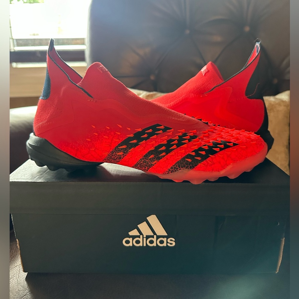 Red and black Adidas predator turf cleats